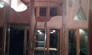 a room with a ladder and windows in a house at Cabanes de moon in Moon-sur-Elle