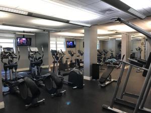 a gym with lots of treadmills and exercise bikes at The Tides Apartment in Hollywood