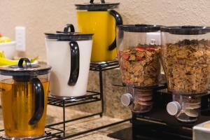 a counter with three jars of food and granola at Heritage Place Hotel and Suites in DeQuincy +14 photos