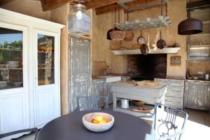 a kitchen with a table with a bowl of fruit on it at Les Bergeries d'Arone in Piana