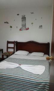 a bedroom with a bed with a lighthouse on the wall at Hostal Balcony in Popayan