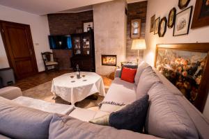 a living room with a couch and a table at Apartament Perła Kartuz z sauną in Kartuzy