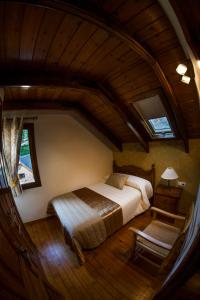 a bedroom with a large bed in a attic at La Borda de Garbi in Piedrafita de Jaca