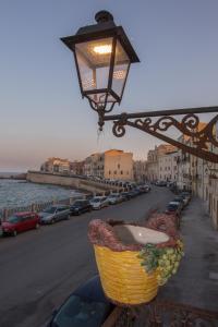 a basket of grapes is hanging from a street light at Blue Levante Vista Mare con terrazza in Syracuse