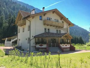 a large house with a balcony on top of it at Genzianella Mansarda Molveno-Andalo in Molveno
