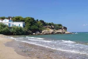 a house on the shore of a beach at Overlooking the blue sea in Rafina