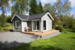 a small shed with a deck in a yard at Landvetter House in Landvetter