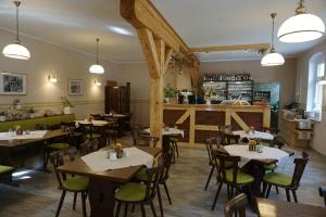 a restaurant with tables and chairs and a counter at Pension Ostrauer Mühle in Bad Schandau
