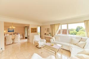 a living room with a white couch and a table at Ferienwohnung Isabella in Ascona