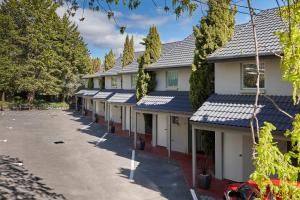 a row of houses with blue roofs at Elphin Serviced Apartments in Launceston