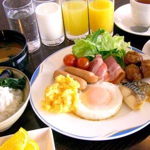 a plate of breakfast food with eggs meat and vegetables at Hotel Kimitsu Hills in Kimitsu
