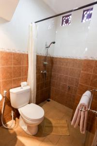 a bathroom with a toilet and a shower at The Jero Ubud in Ubud