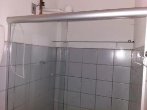 a shower with a glass door in a bathroom at Chale do Guidon in Imbassai +40 photos