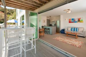 a kitchen and living room with a table and chairs at Robins Nest in Russell