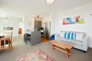 a living room with a couch and a table at Robins Nest in Russell +7 photos