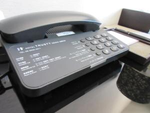 a telephone sitting on top of a desk at Hotel Trusty Osaka Abeno in Osaka