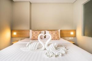 Tempat tidur dalam kamar di Maple Hotel Grogol