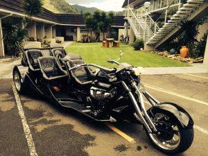 a black motorcycle parked in a parking lot at Picton Accommodation Gateway Motel in Picton