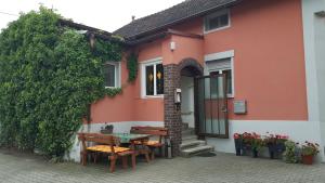 a house with a table and chairs in front of it at Pension Holzgarten in Regensburg
