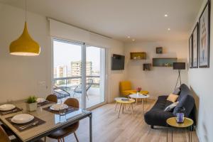 a living room with a couch and a table at Apartamentos Dubamar in Aguadulce
