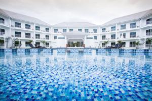 a swimming pool in front of a hotel at White House in Tak