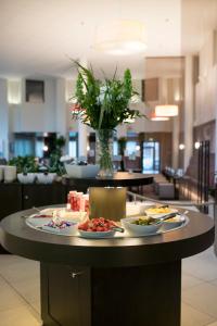 a table with plates of food on it in a restaurant at Hotel Pommern in Mariehamn