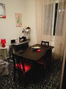 a dining room with a black table and chairs at Appartamento Porzione di villa "il cappello d'oro" in Chiavari