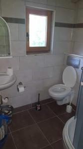 a bathroom with a toilet and a sink and a window at Holiday Home Kite House in Ulcinj +35 photos