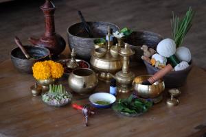 a table topped with lots of metals and flowers at Amnaya Resort Kuta in Kuta