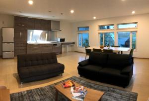 a living room with a couch and a table at Lodge Mori Apartments in Kutchan