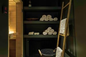 a shelf with plates and a basket on it at Loft Living Garden Suite in Nieuwpoort