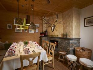 a dining room with a table and a fireplace at AlpenOase Sonnhof in Saalbach-Hinterglemm