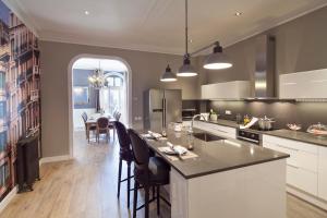 a kitchen with a island with chairs and a table at Apartments Barcelona & Home Deco Centro in Barcelona