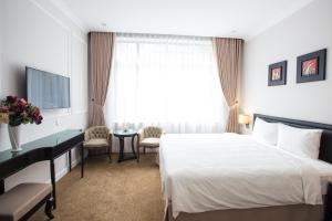 Ένα ή περισσότερα κρεβάτια σε δωμάτιο στο Dinh Elegant Hanoi Hotel