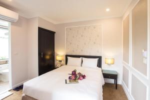 Ένα ή περισσότερα κρεβάτια σε δωμάτιο στο Dinh Elegant Hanoi Hotel