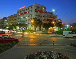 a city street at night with a building at Olympic Palladium in Rethymno