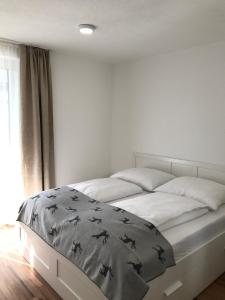 a bedroom with a large bed with black birds on it at Appartement Tirolina in Innsbruck