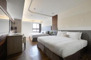 Taichung saint hotel tesisinde bir odada yatak veya yataklar