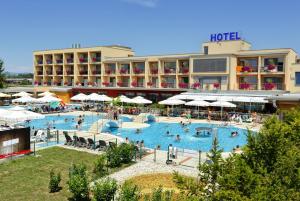 a hotel with a large pool with people in it at Terme Paradiso - Hotel Paradiso in Dobova