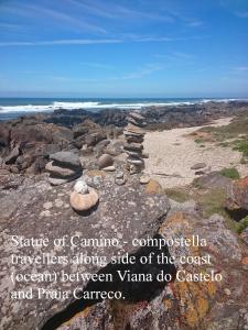 a pile of rocks on a rocky beach with the ocean at CasaRada in Carreço