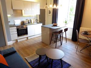 a kitchen and living room with a table and chairs at The Smeaton at Claremont Apartments in Leeds