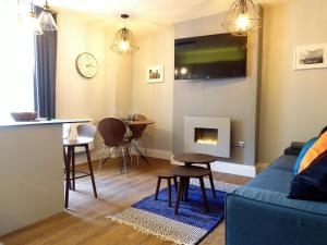 a living room with a couch and a table at The Smeaton at Claremont Apartments in Leeds