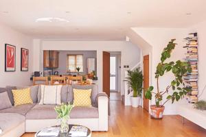 a living room with a couch and a table at Twitchers Lodge in Cirencester