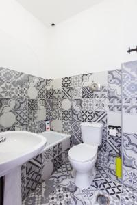 a bathroom with a toilet and a sink at Balili Surf House in Baleal +73 photos