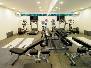 a gym with several treadmills and cardio machines at The Bale Phnom Penh by LifestyleRetreats in Phnom Penh