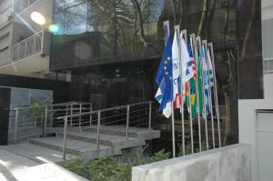 a group of flags hanging outside of a building at Palm Beach Plaza Hotel in Montevideo