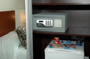 a microwave sitting on a shelf in a bedroom at Palm Beach Plaza Hotel in Montevideo