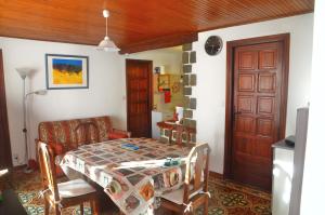 a dining room with a table and a chair at Location Pierre in Tende