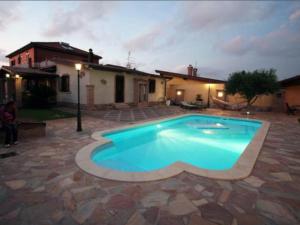 a swimming pool in a yard with a house at Number60 in Fiumicino