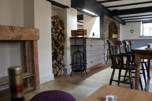 a room with chairs and a table and a fireplace at The Hatch Inn in Taunton
